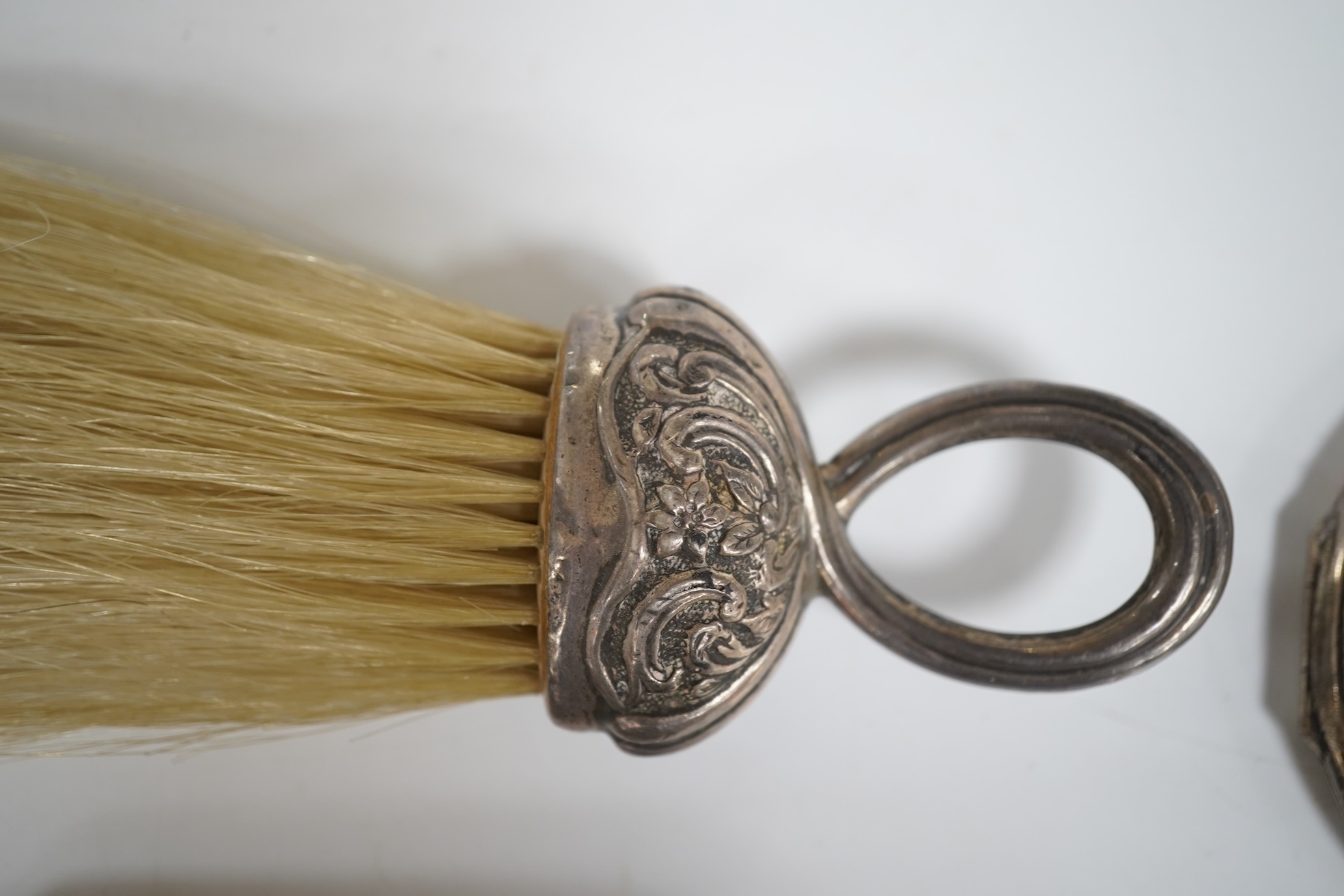 An Art Deco silver mounted hand mirror by Collett & Anderson, London, circa 1930, 22.7cm, together with a silver mounted crumb brush, clothes brush and an engine turned silver compact.